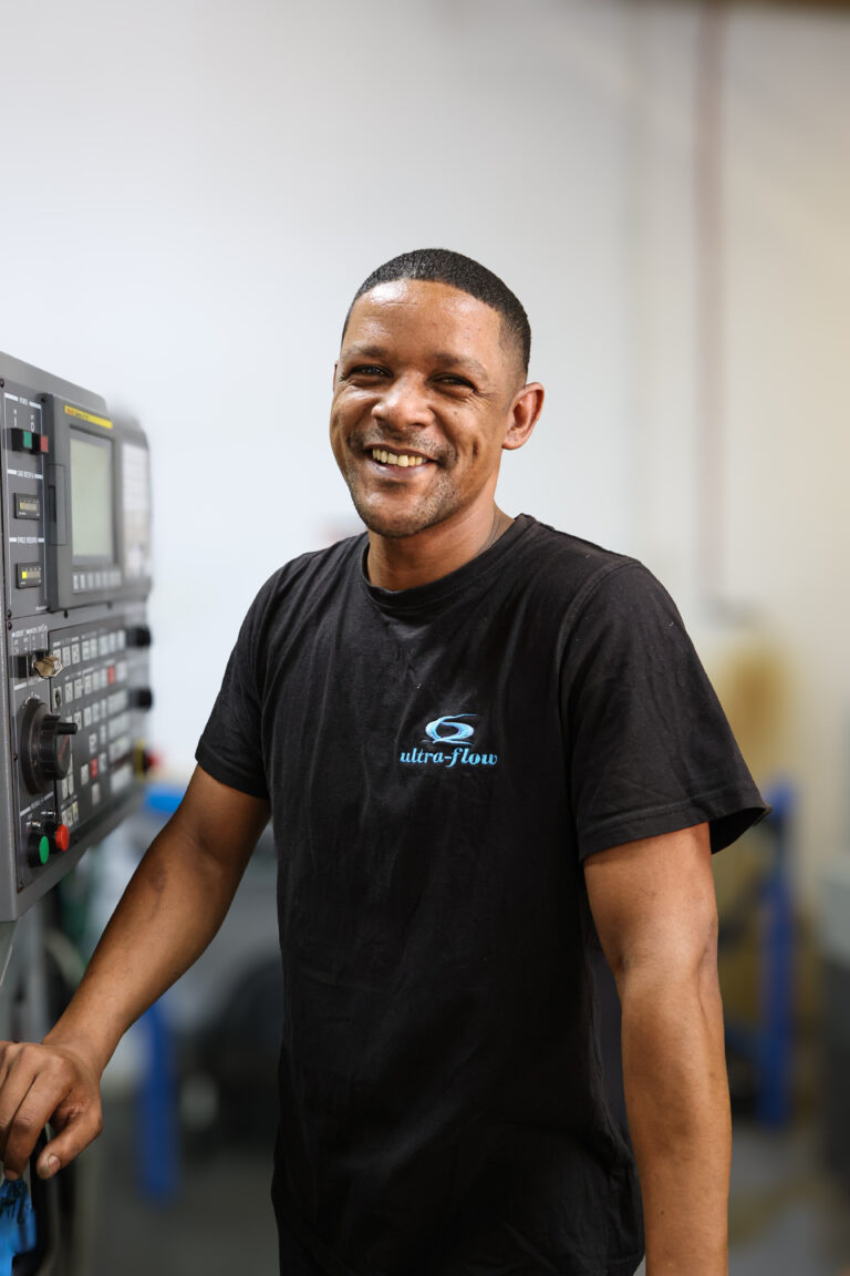 Ultra-Flow team member — beside the cnc machines