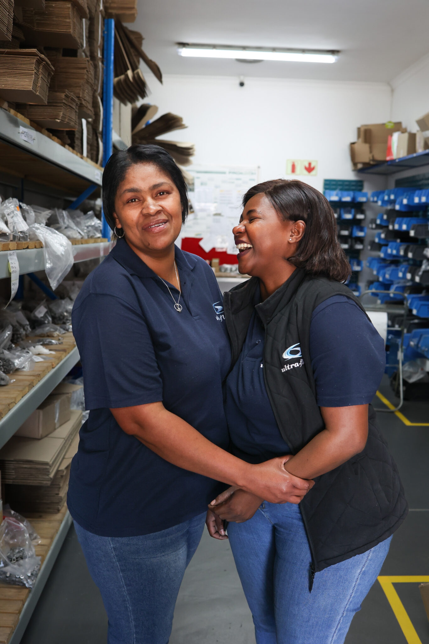 Two Ultra-Flow team members sharing a laugh in stores