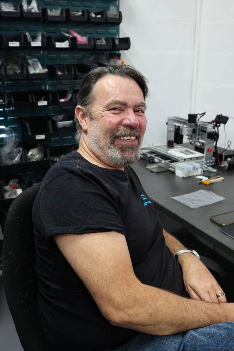 Ultra-Flow team member — at the assembly bench