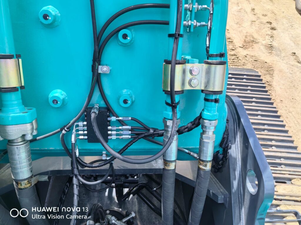 Lubrication pump and lines in an excavator engine bay