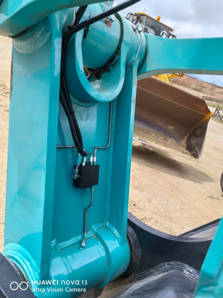 Detail of lubrication line routing on an excavator