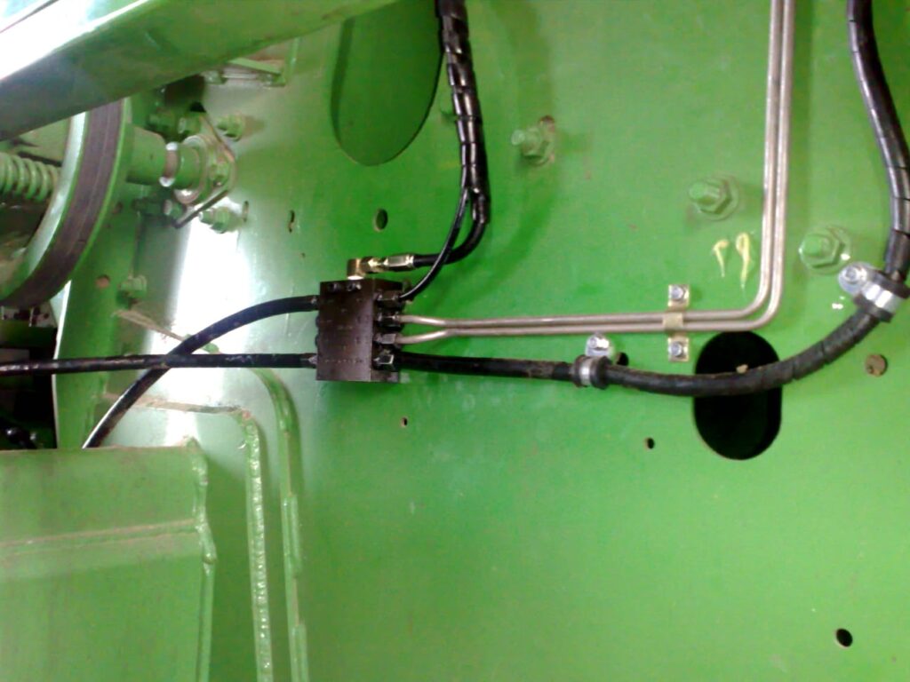 Lubrication line and fitting detail on green agricultural machinery