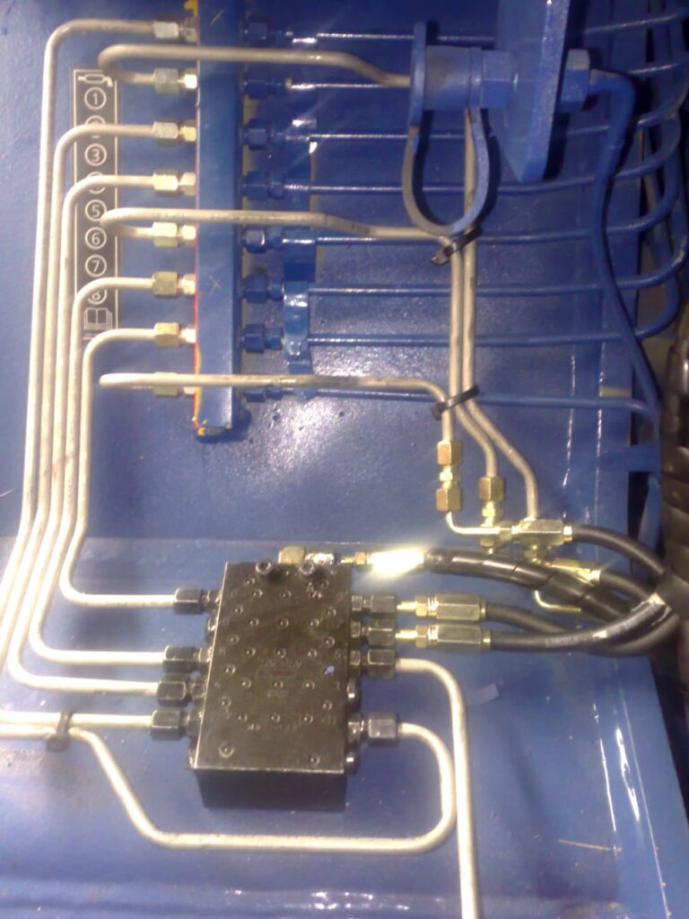 Steel lubrication lines routed across machinery structure